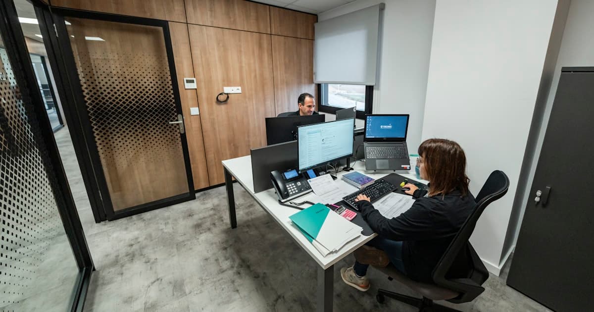 People work at desks in a modern office.